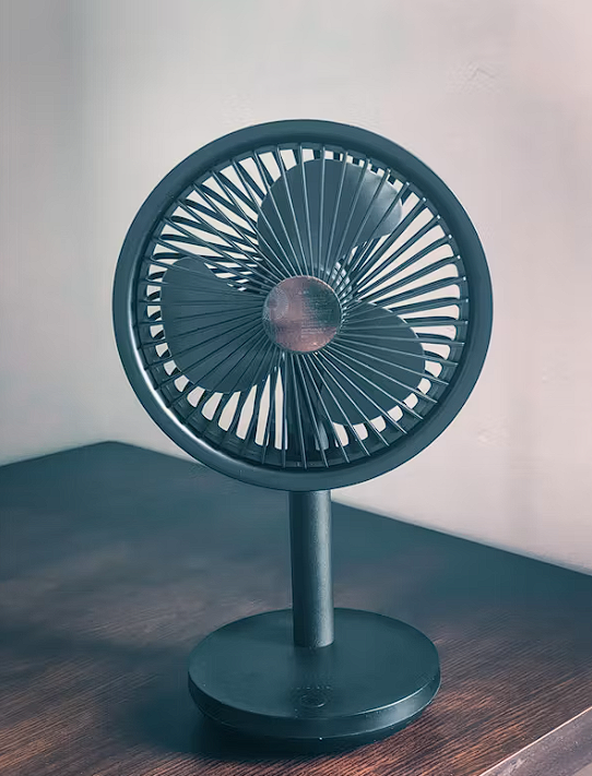 Small USB desk fan on a table