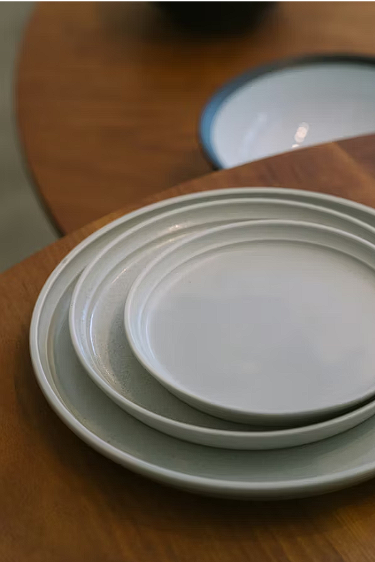 Stack of white ceramic dinner plates