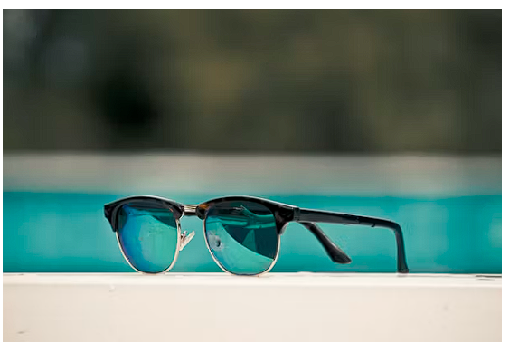 Stylish sunglasses on a bright background